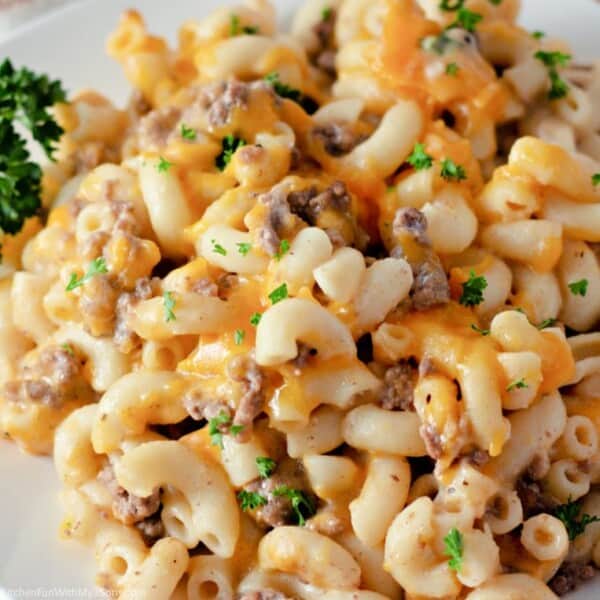 A close-up image of hamburger helper pasta with a garnish of chopped fresh parsley