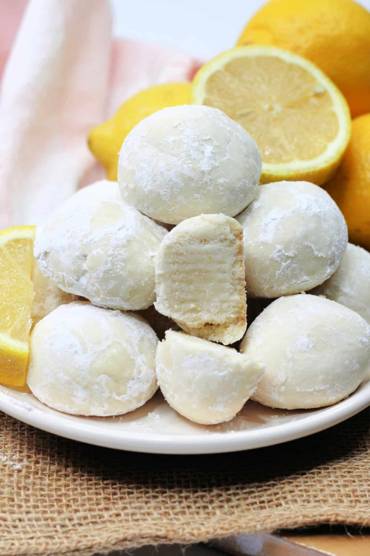 These Lemon Snowball Cookies are a refreshing melt-in-your-mouth twist on classic snowball cookies. Lemon Snowball Cookies stacked on a plate