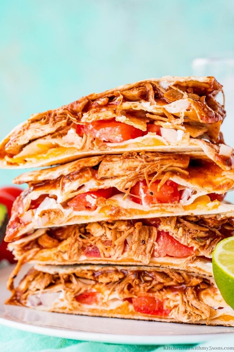 A close up of BBQ chicken quesadilla wraps stacked on each other.