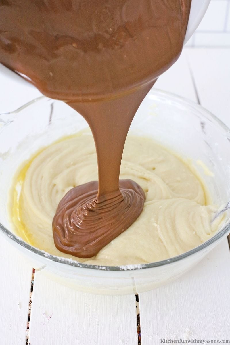 Adding the melted chocolate into the batter.