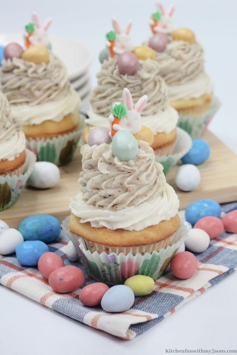 Cupcakes with a bunch of robin eggs around them.