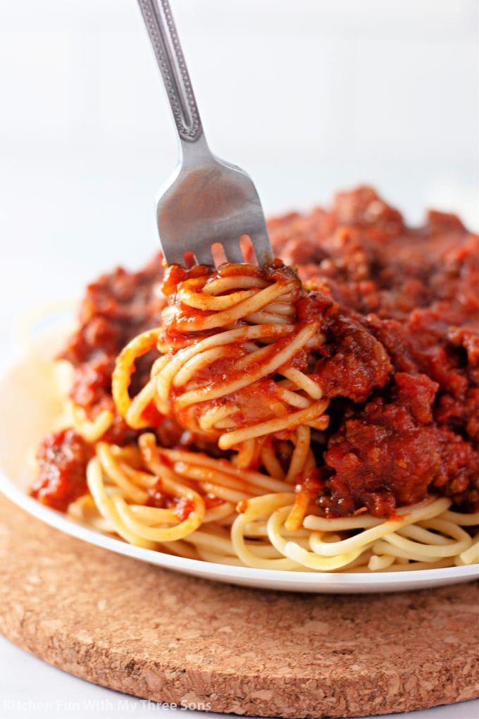 twirling spaghetti and meat sauce on a fork.