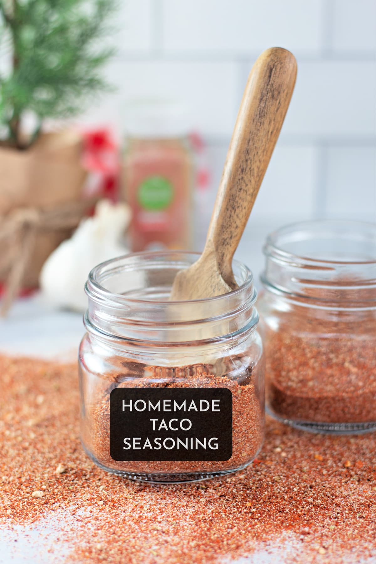 A wooden spoon in a small jar of homemade taco seasoning