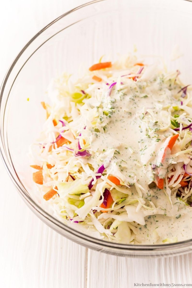 Combining the dressing and slaw.