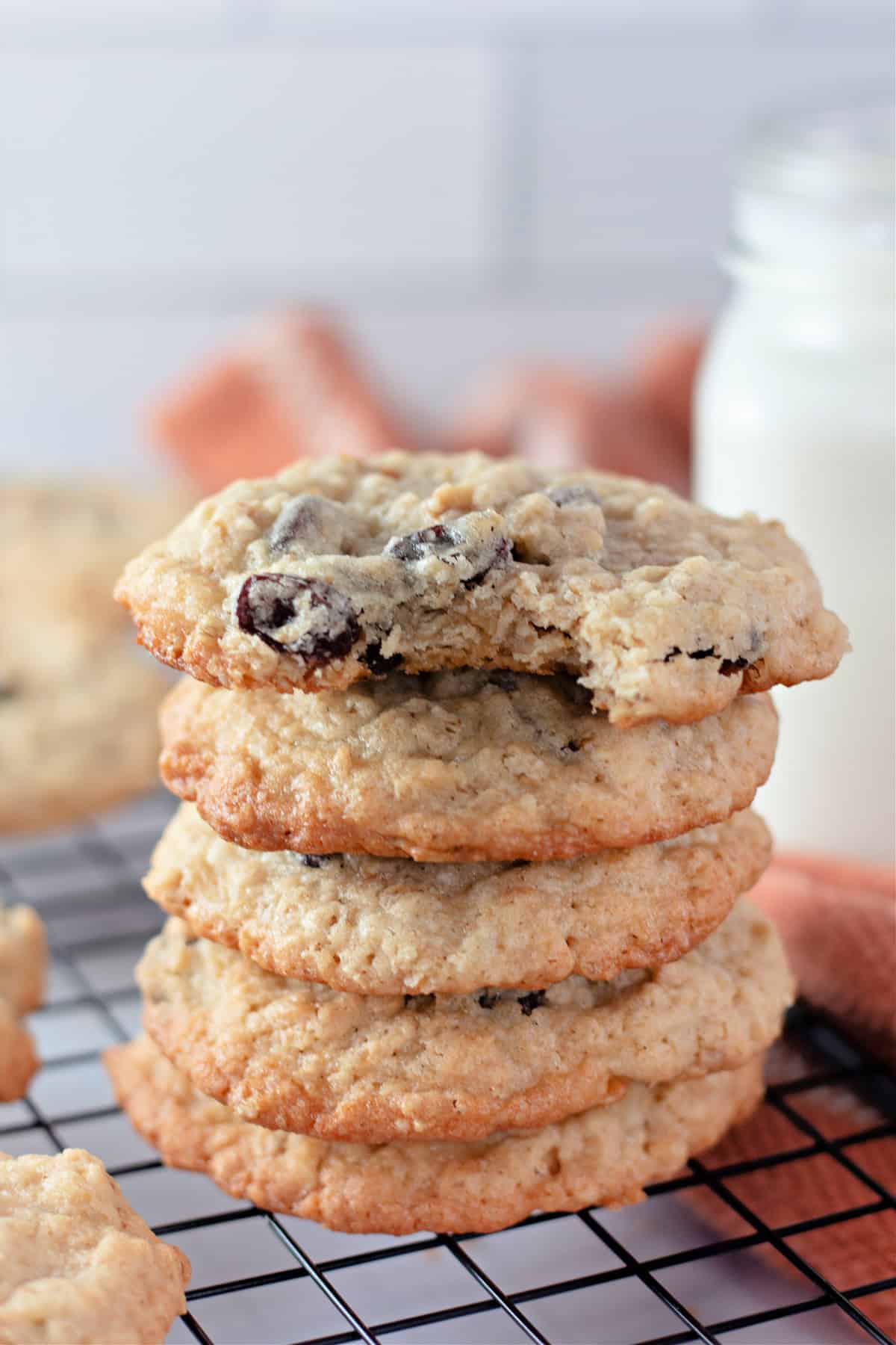 These Chewy Oatmeal Raisin Cookies are perfectly soft in the center and crisp on the outside. No chilling required! A stack of oatmeal raisin cookies on a cooling rack