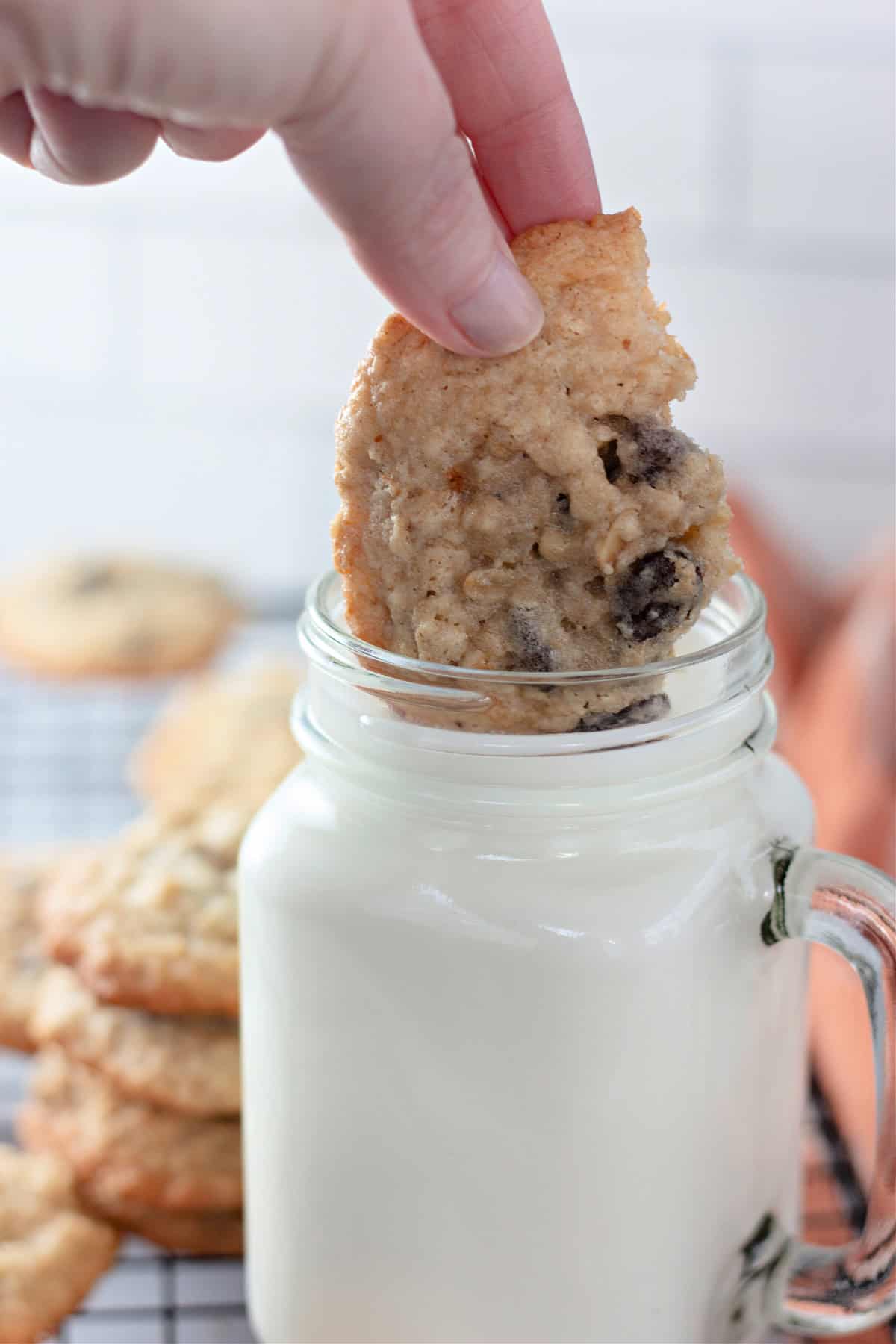 Dunking an oatmeal raisin cookie in a glass of milk