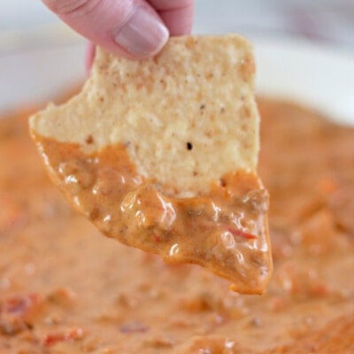 Tortilla chip scooping up Rotel dip.