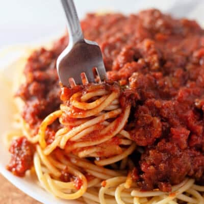 A fork twirling spaghetti with meat sauce