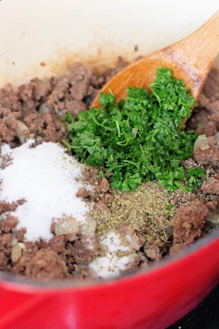 Italian sausage and ground beef are simmered with crushed and fire roasted tomatoes to make this the BEST Spaghetti Meat Sauce recipe. Sugar, seasonings, and parsley added to cooked ground beef and pork
