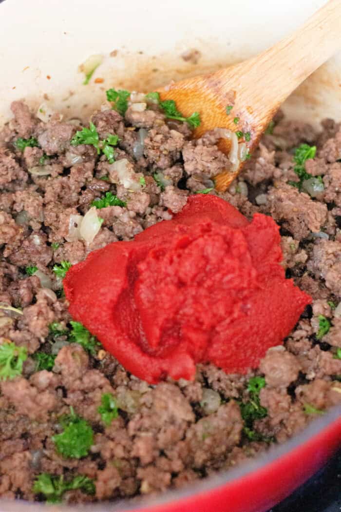 Italian sausage and ground beef are simmered with crushed and fire roasted tomatoes to make this the BEST Spaghetti Meat Sauce recipe. Tomato paste added to ground beef and pork