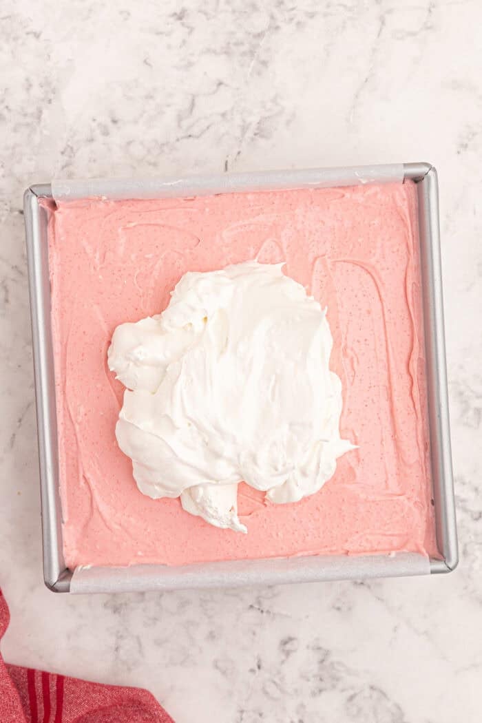 Cool Whip added on top of a strawberry cream cheese mixture.