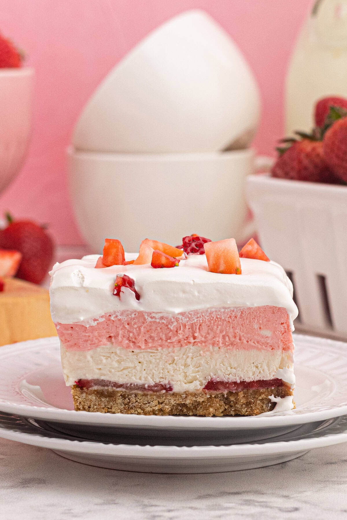 A slice of strawberry delight on a white plate