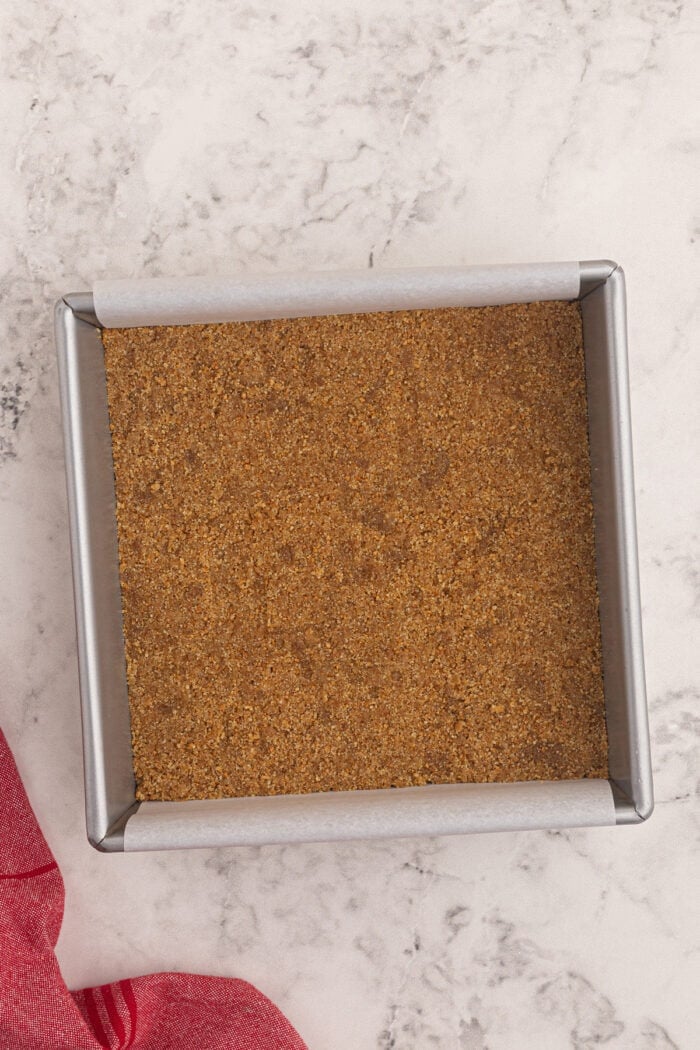 Graham cracker crust pressed into a square pan