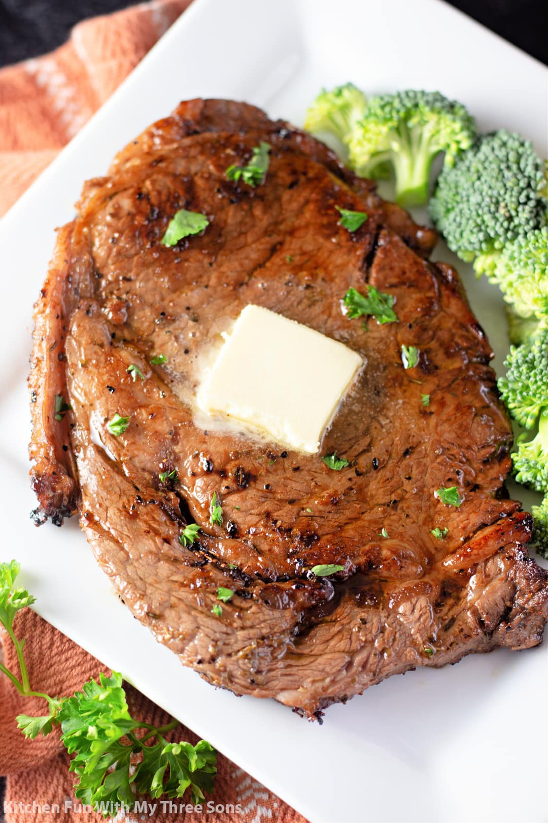 freshly made steak with butter and broccoli.
