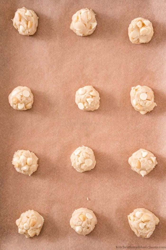 White Chocolate Macadamia Nut Cookie Dough Balls on a baking sheet