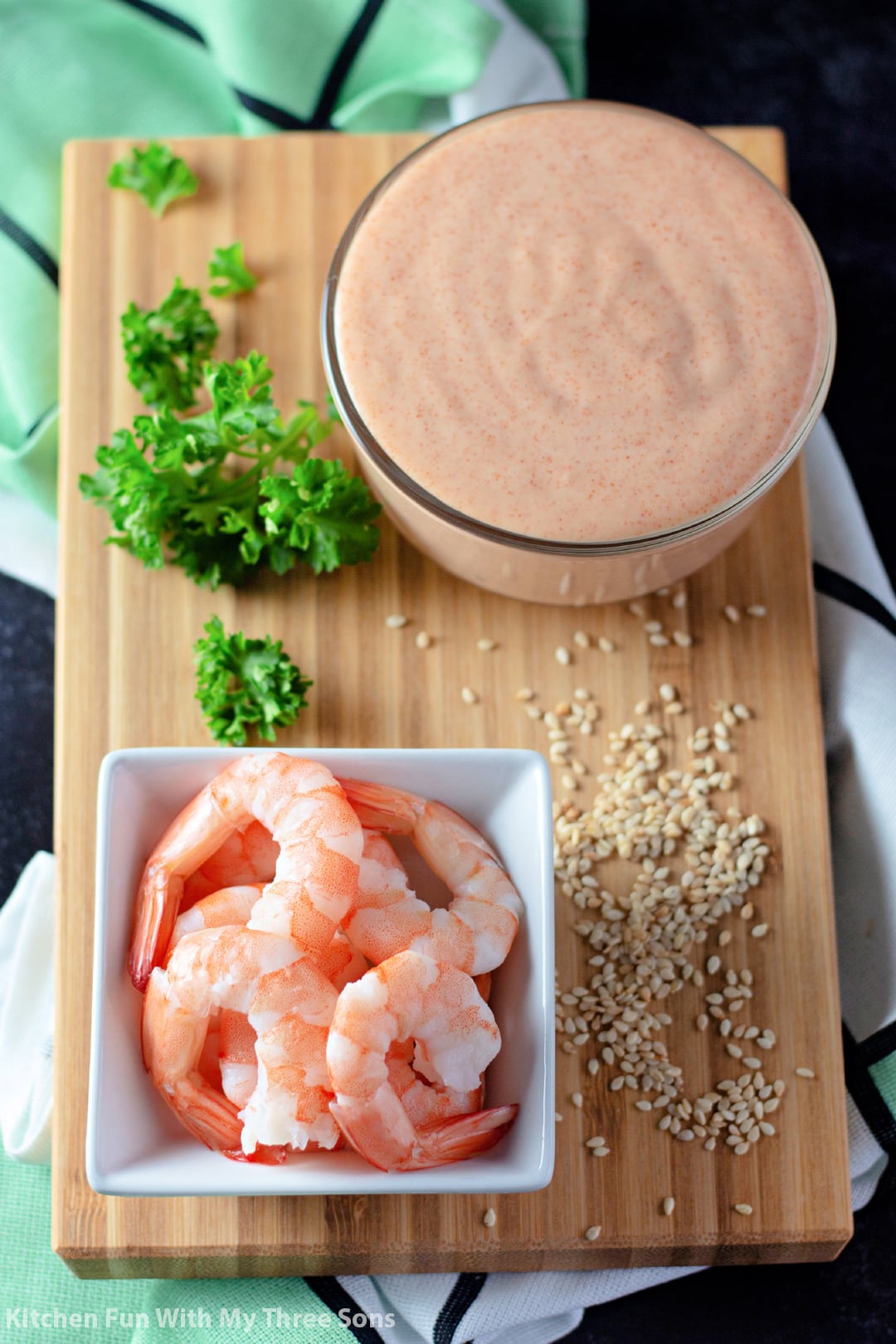 Homemade Yum Yum Sauce on a bamboo board with shrimp.