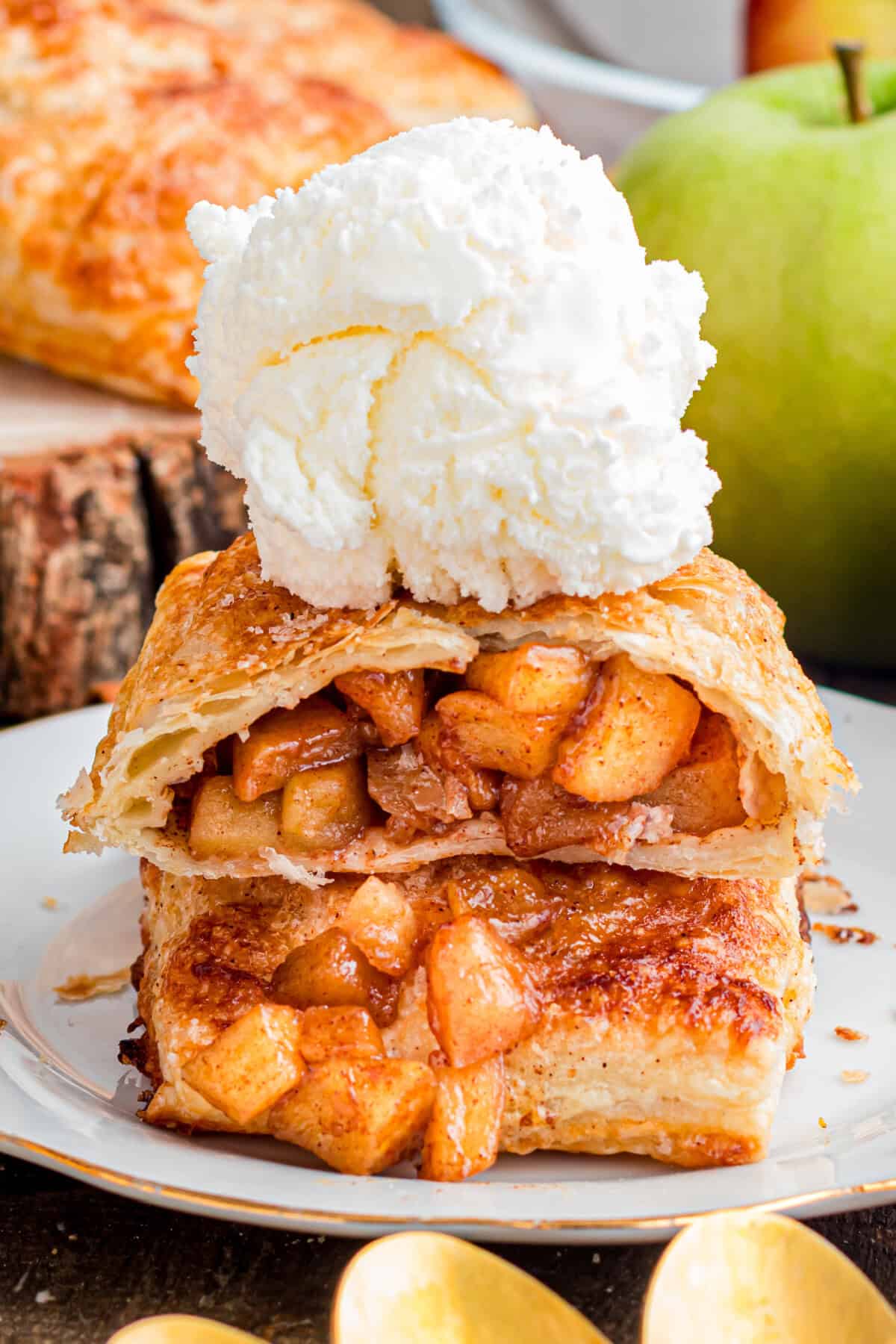 These Apple Hand Pies are filled with gooey apple pie filling wrapped in flaky puff pastry and baked until deeply golden and crisp. Apple Hand Pies topped with Ice Cream.