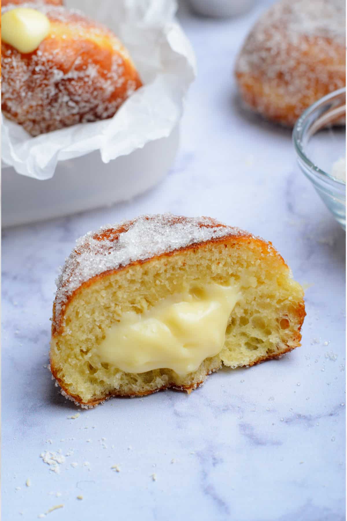 a vanilla cream filled donut cut in half