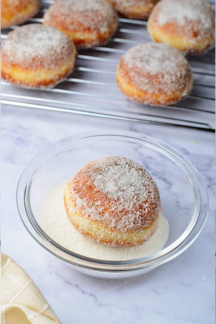 covering the donuts in sugar