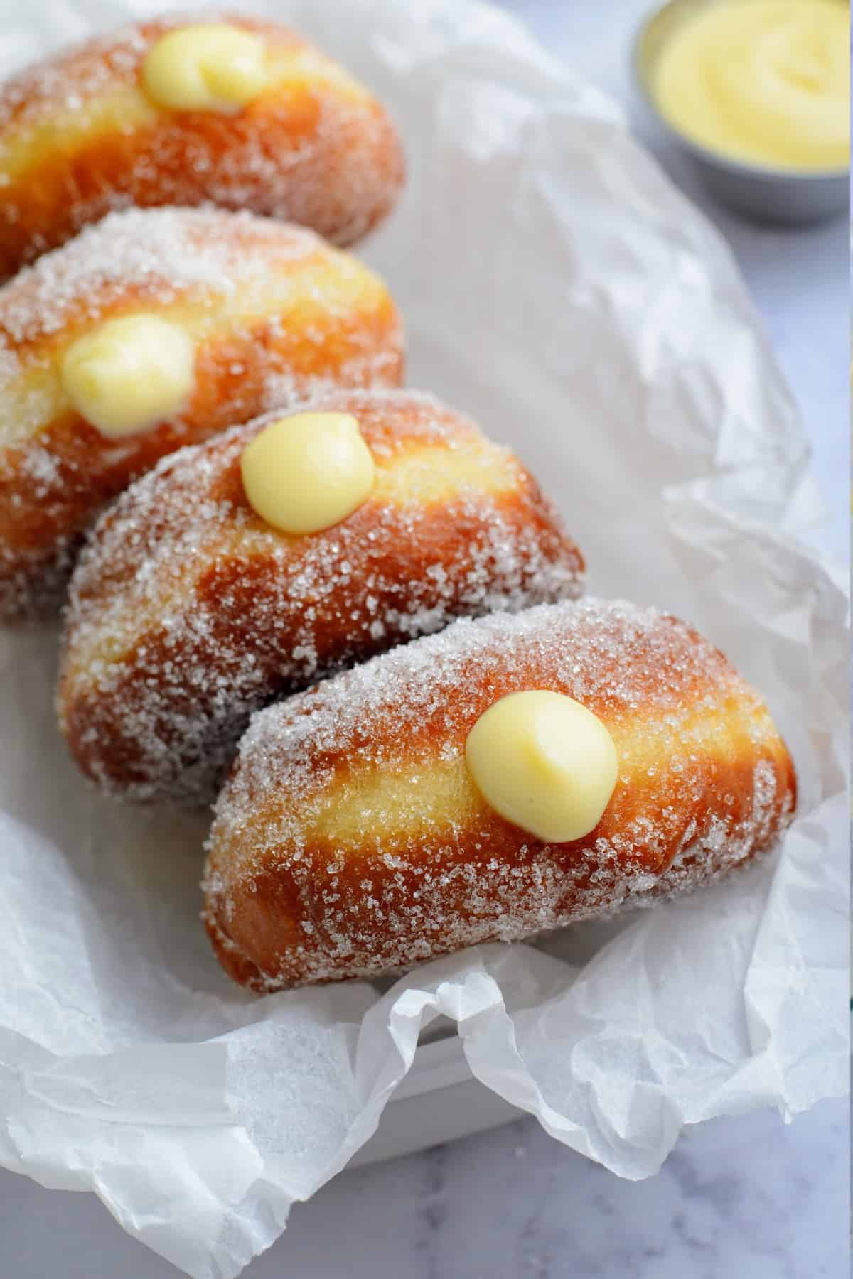 These Brioche Cream Filled Donuts are perfectly fluffy and just like what you find at a bakery. Vanilla Cream Filled Donuts