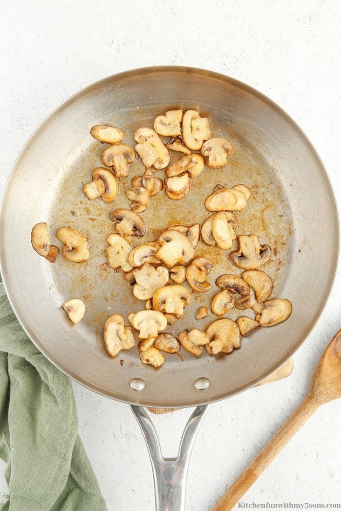 sauteing mushrooms in a pan