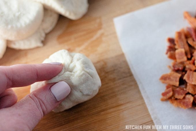 pinching biscuit dough into balls.