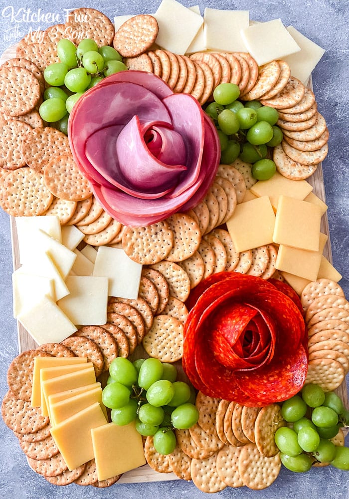 Overhead view of a charcuterie board with a ham rose