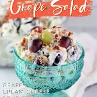 Grape salad with sweet cream dressing in a blue bowl.
