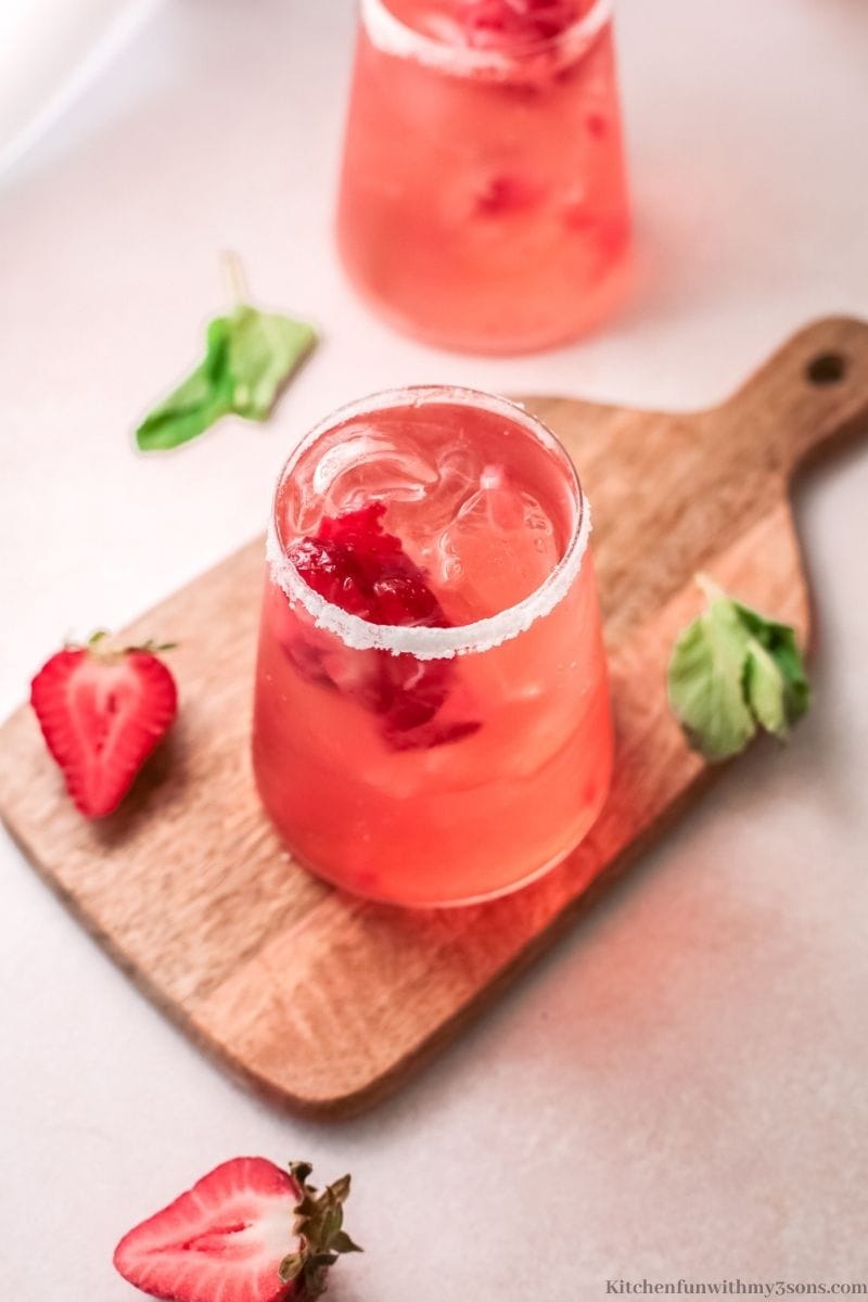 The cocktail with extra cut of strawberries.