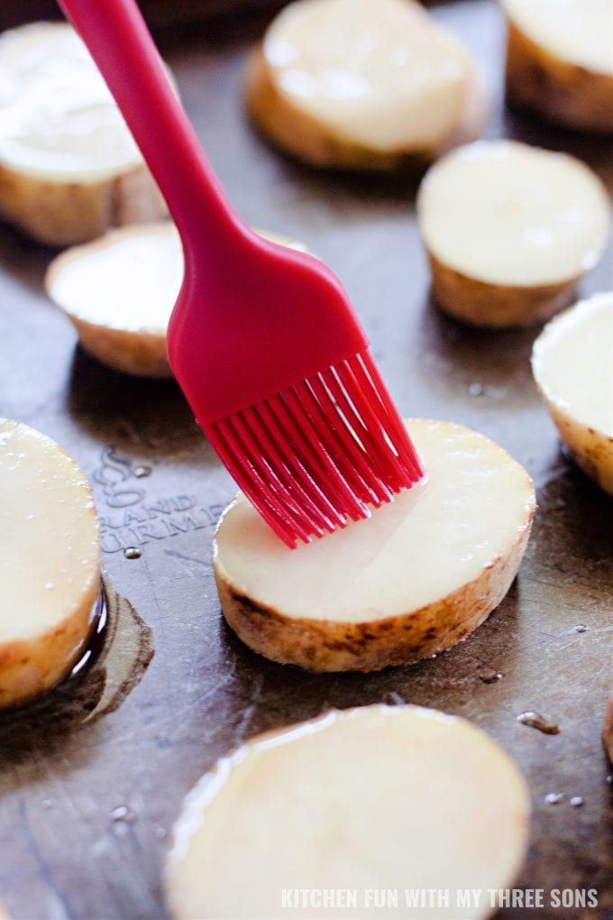 brushing potato slices with oil.