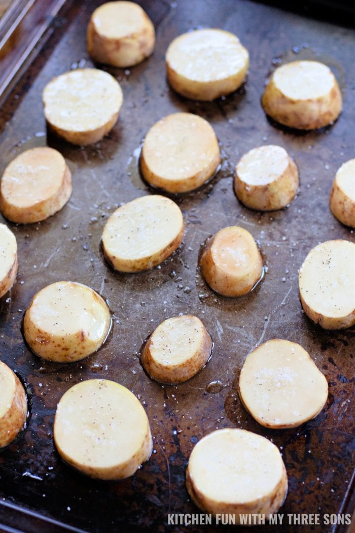 baking potato slices on a cookie sheet.