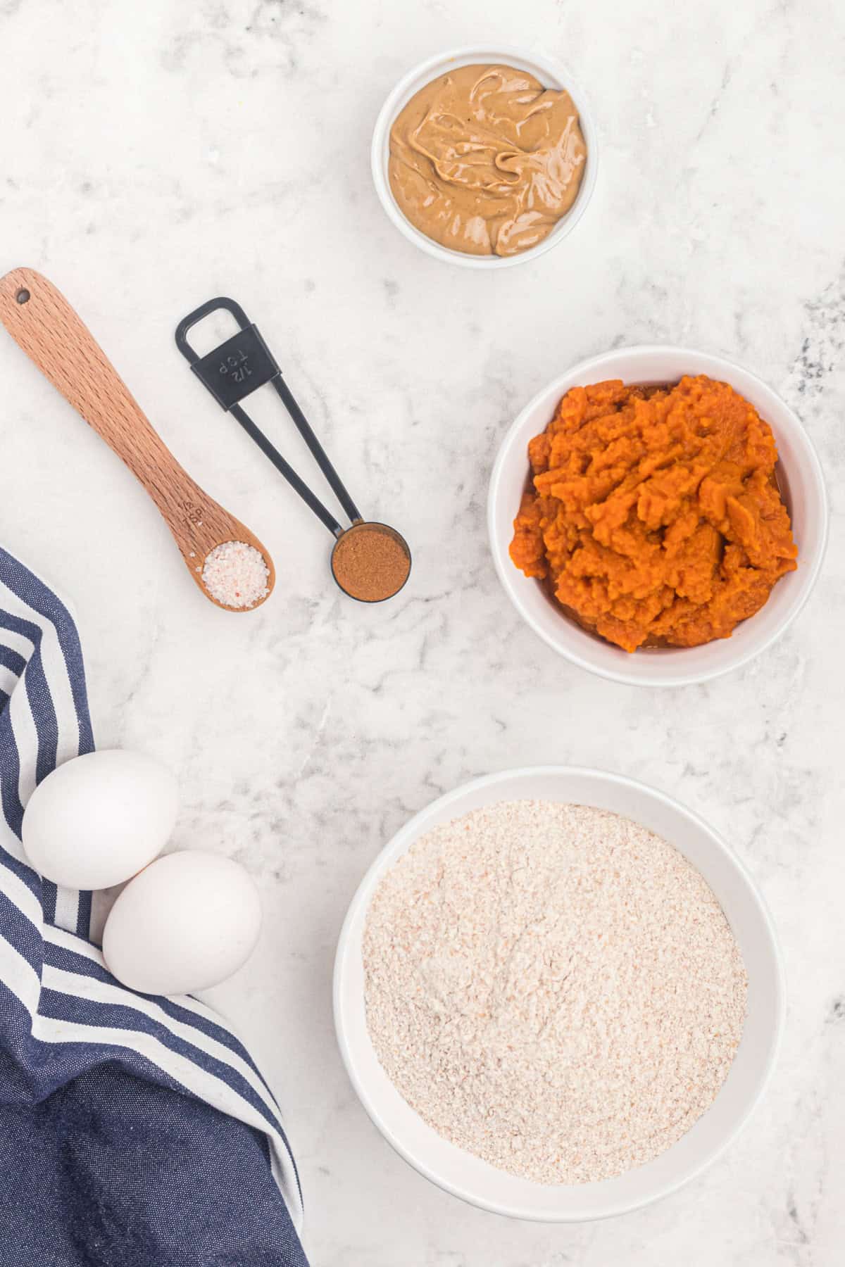 These easy Homemade Dog Treats are made with pumpkin, peanut butter, whole wheat flour, eggs, and a little cinnamon. Ingredients for Homemade Dog Treats