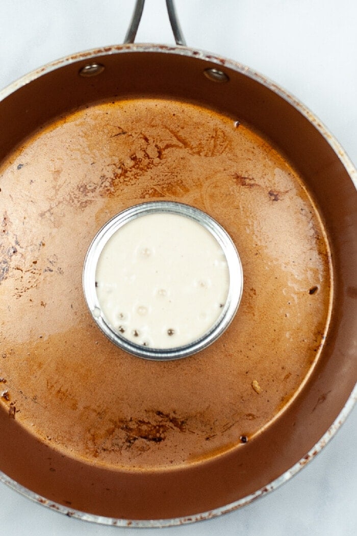pancake mix inside a mason jar ring on a pan