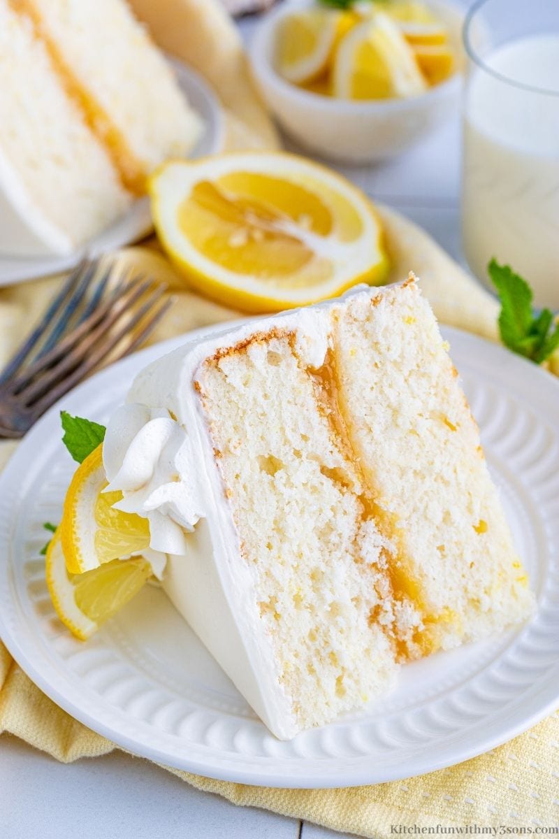 A piece of cake with lemon wedges.