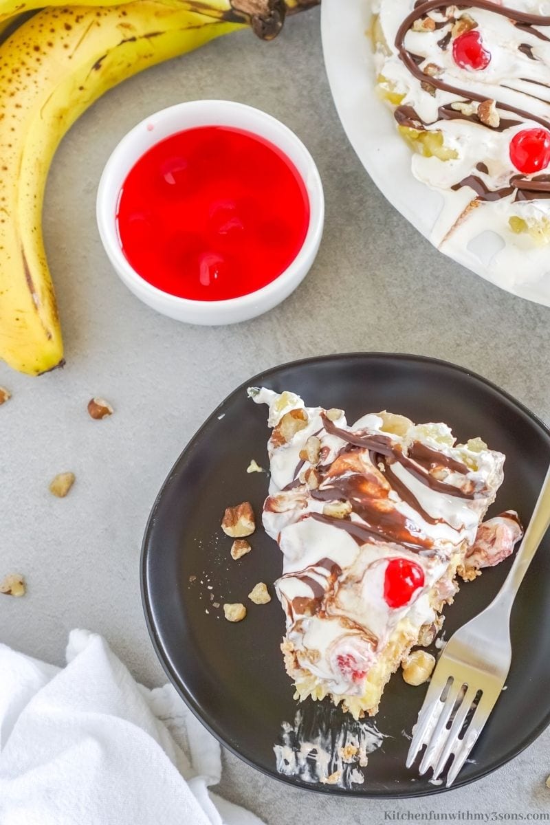 A piece of the banana split pie pie with extra ingredients on the side.