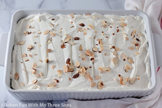 topping the dessert with Cool Whip and almonds.