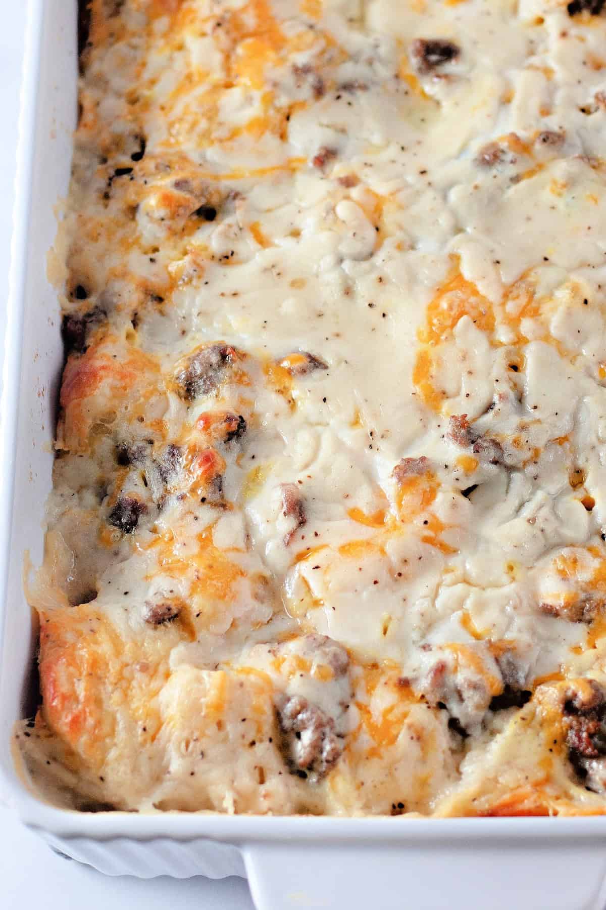 This savory Biscuits & Gravy Casserole recipe has it all - biscuits, breakfast sausage, cheese, eggs, and gravy. Biscuit and Gravy Casserole