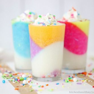 Three cups of gelatin topped with sprinkles.