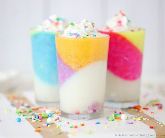Three cups of gelatin topped with sprinkles.