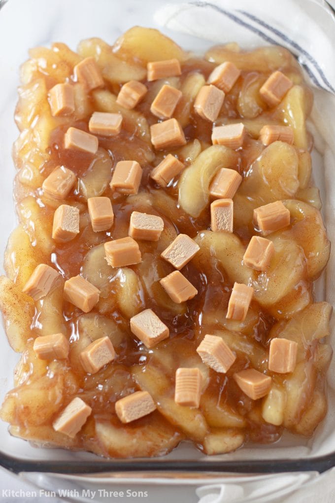 adding sliced caramels over top of the apples.