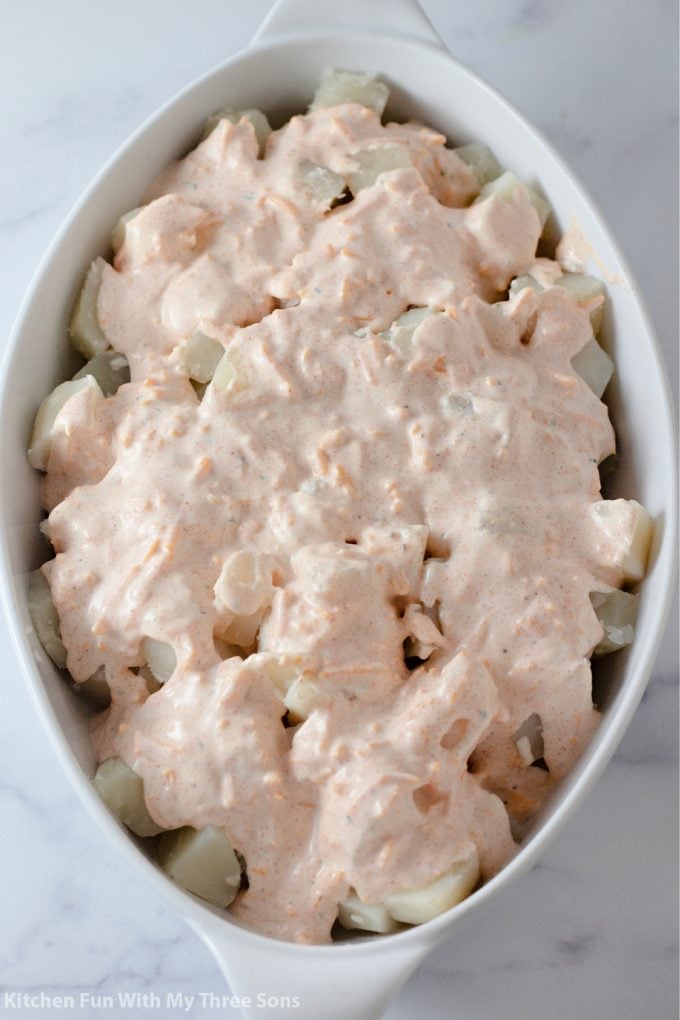 potatoes topped with ranch sauce.