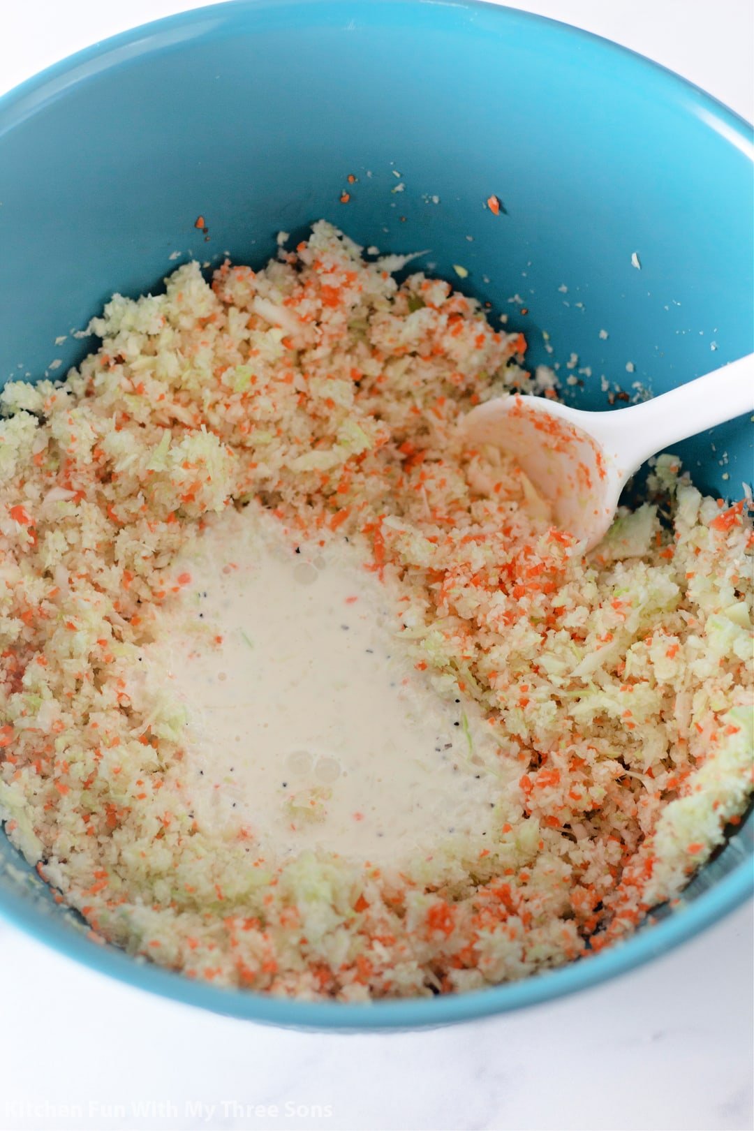KFC coleslaw ingredients in a blue bowl being mixed