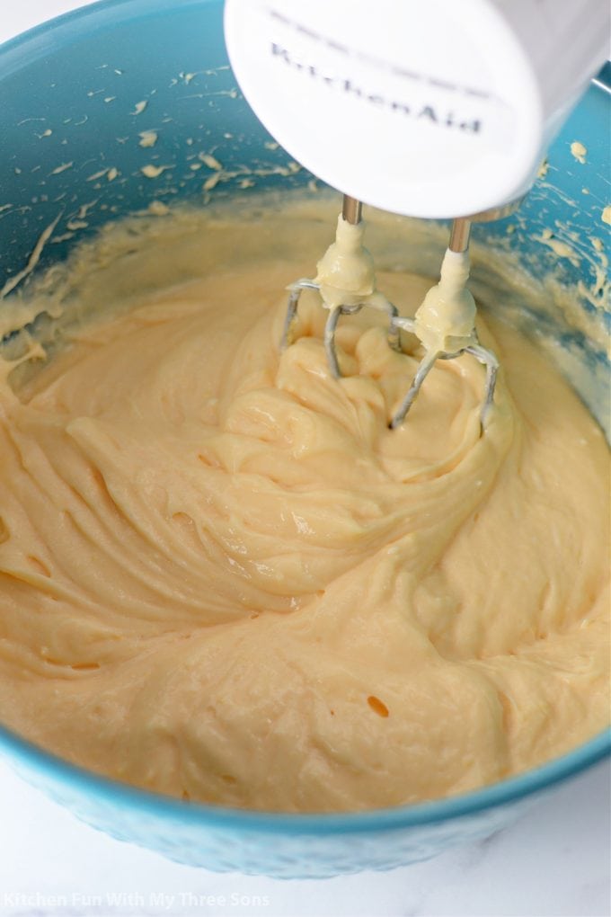 mixing up cream filling for the Cream Puff Cake.