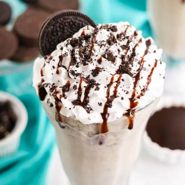 The milkshake garnished with a chocolate drizzle.