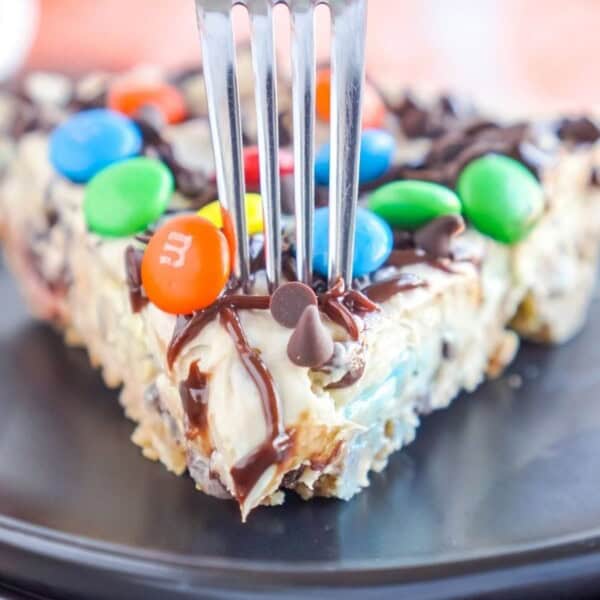 A fork getting ready to take a chunk out of the cheesecake.