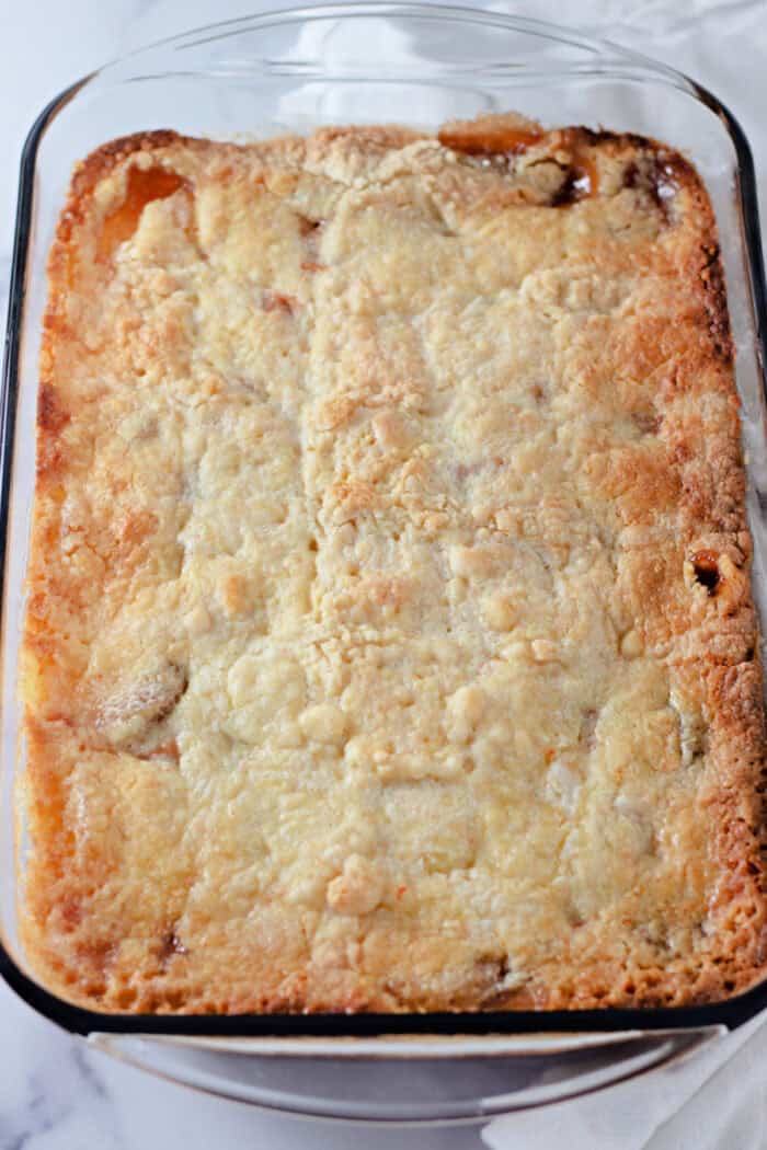 baked caramel apple dump cake in a pan