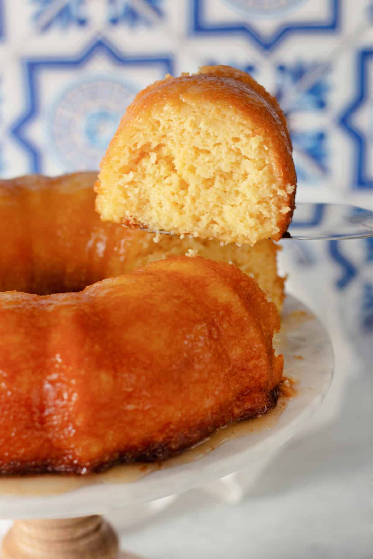 This beautiful golden Pineapple Bundt Cake is full of pineapple flavor right down to the sweet glaze. a slice of pineapple bundt cake