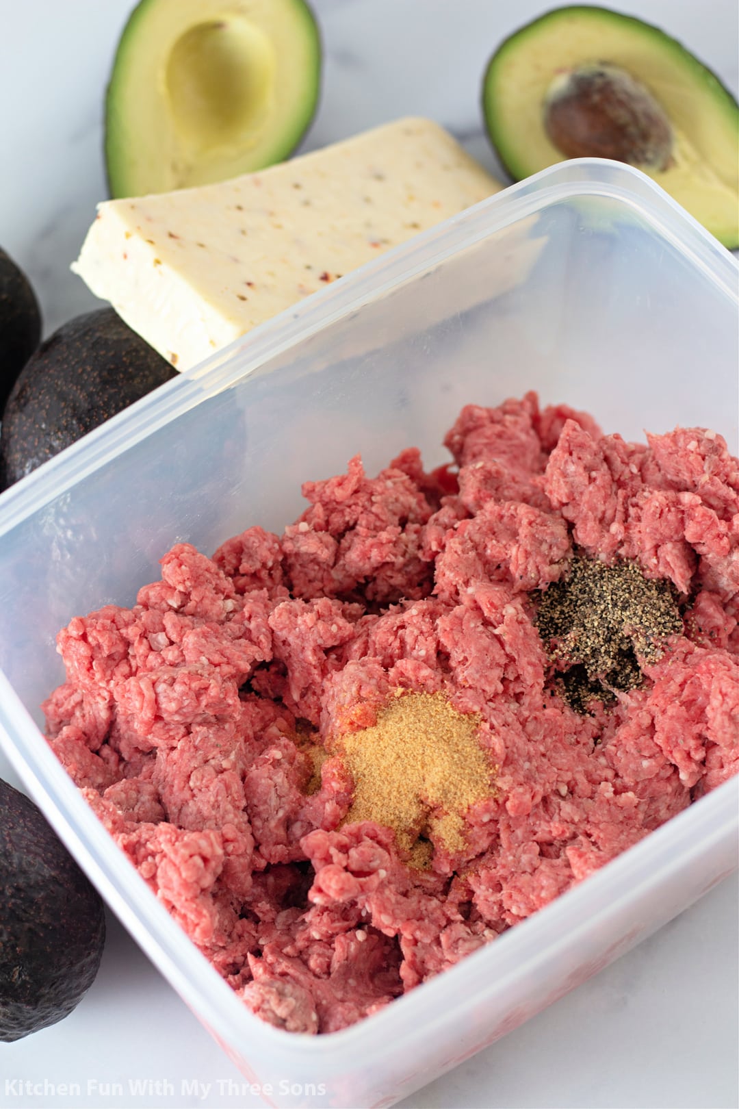 mixing seasoning into the ground beef.