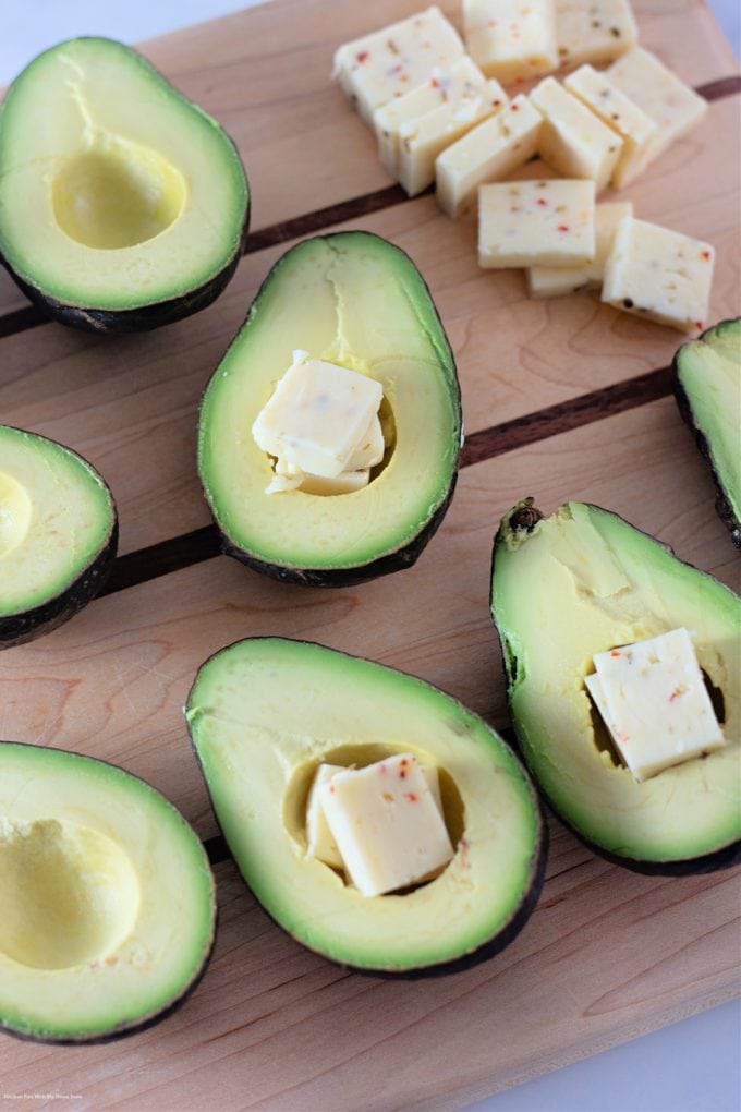 stuffing avocados with pepper jack cheese.