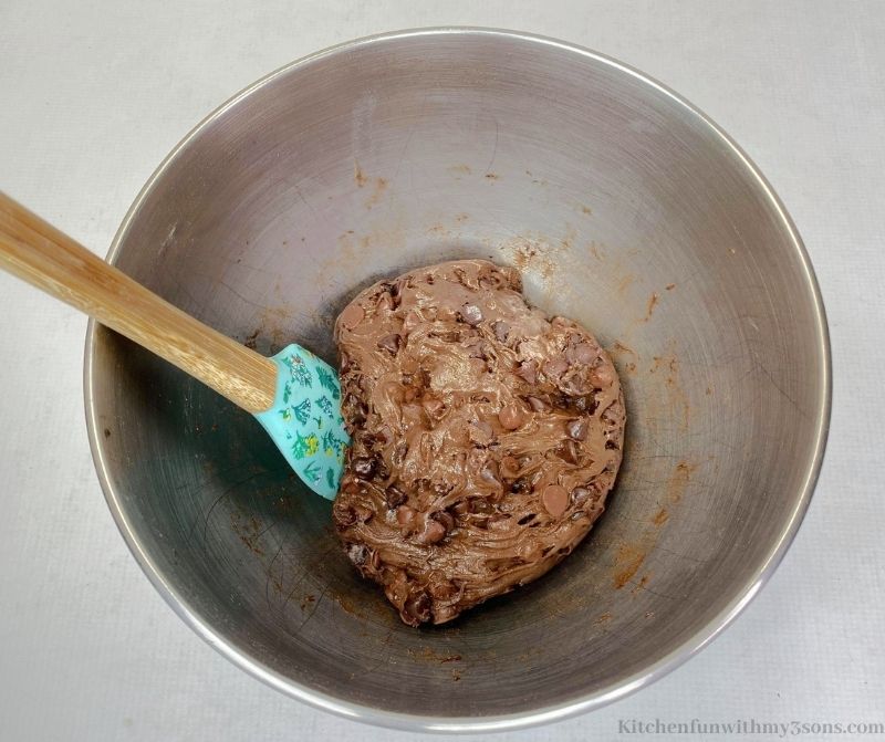 Combining the dough in a mixing bowl.